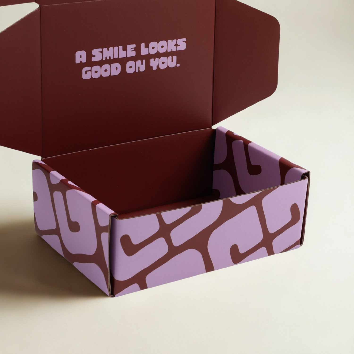 Open purple box and text 'A smile looks good on you'